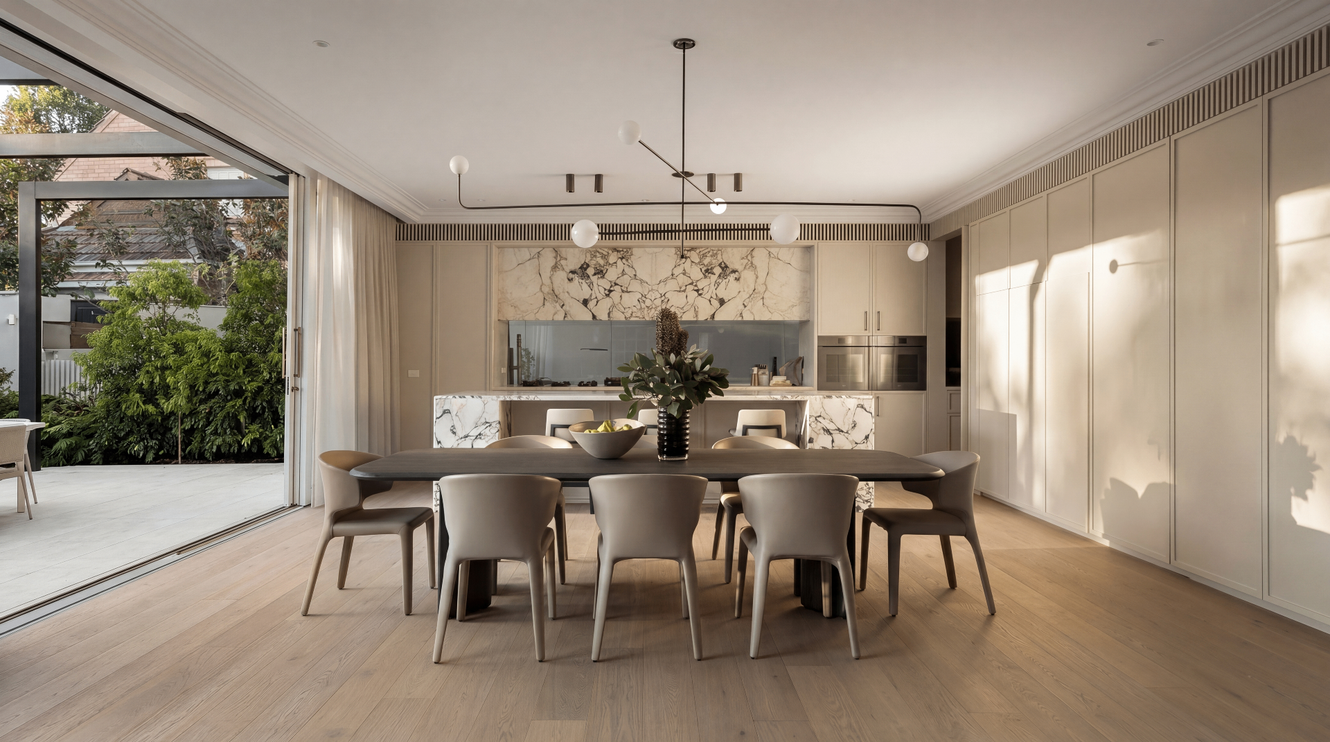 Calacatta Luxe Island Kitchen — Luxury contemporary — stone-wrapped island, blue glass splashback, doors on